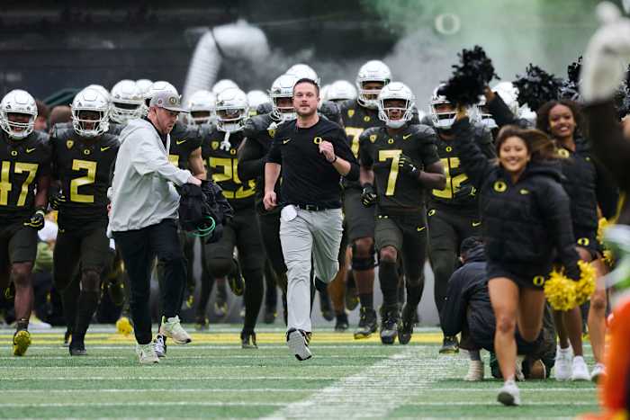 Nov 4, 2023; Eugene, Oregon, USA; Oregon Ducks head coach Dan Lanning runs out to the field with players before a game against the California Golden Bears at Autzen Stadium.